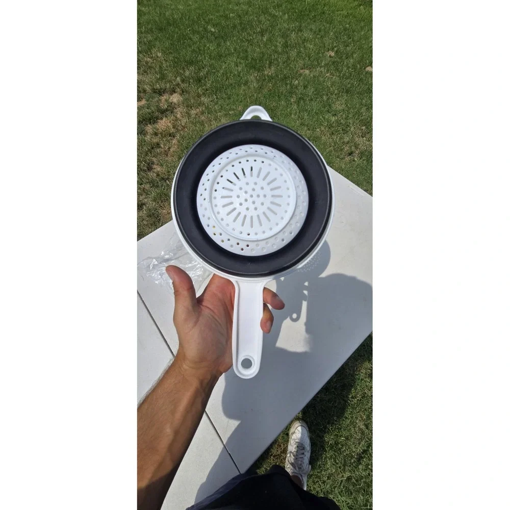 white and black collapsible kitchen strainer or colander Aetna branded handle